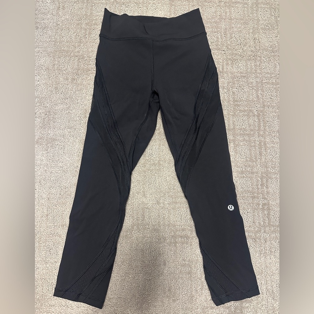 Lululemon 7/8 black leggings with mesh detail.